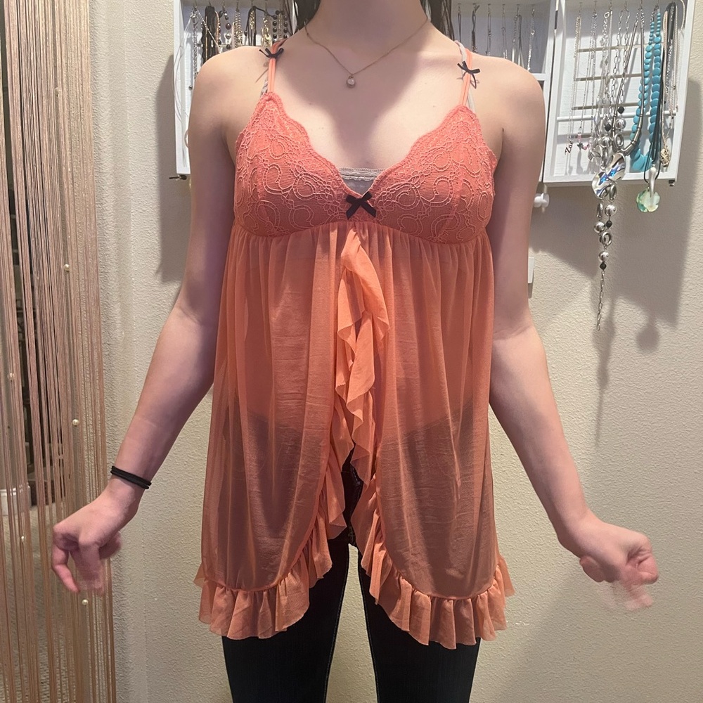 pinkish-orange lingerie top with navy blue bow details. no cup or wires.